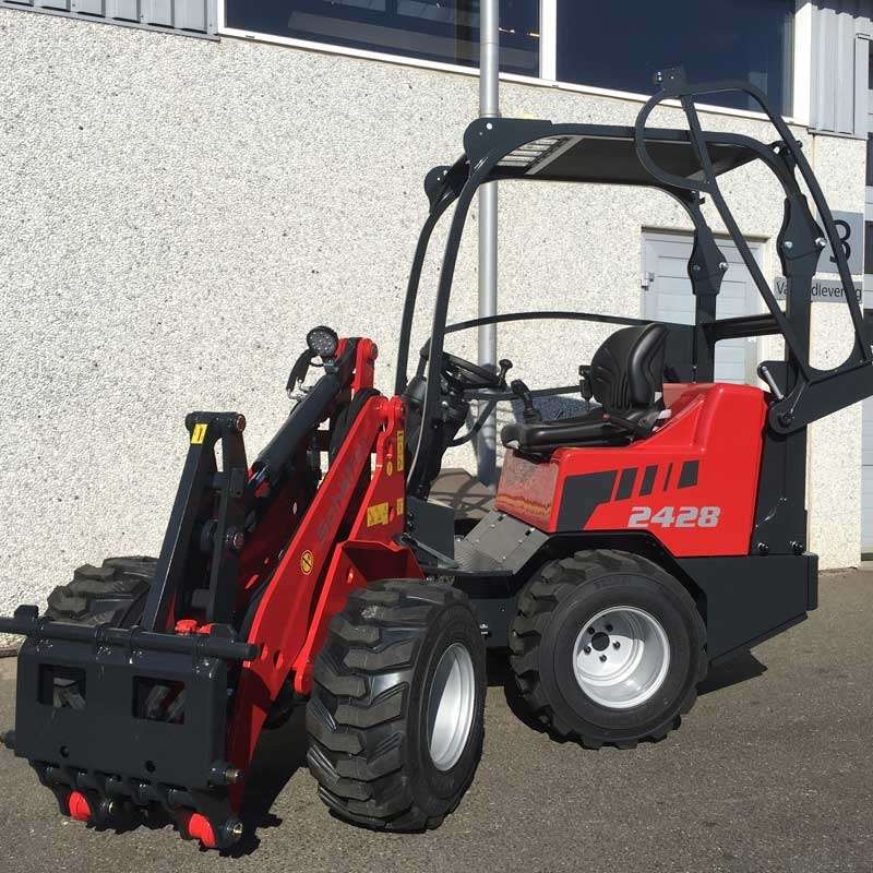 Eight shirts arranged on table in black, olive, grey, blue, white, red, mustard, and green.